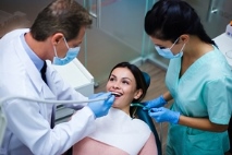 Dentist and assistent treating patient